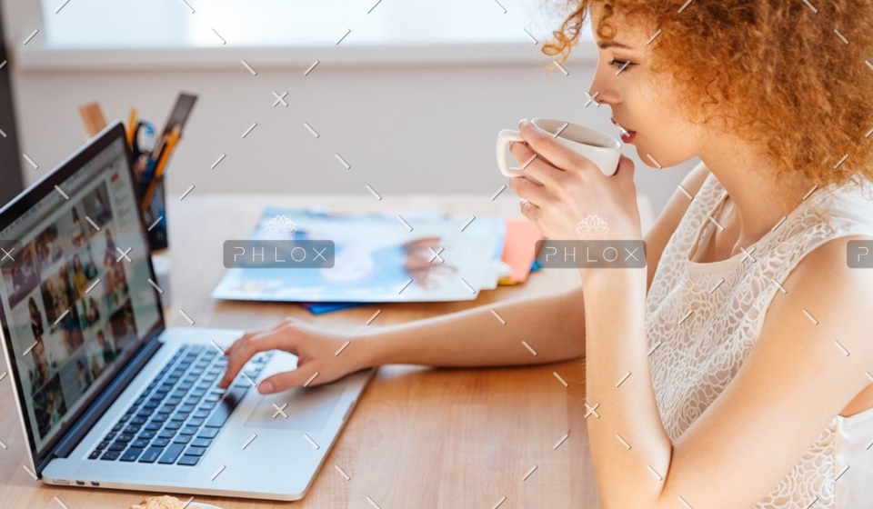 demo-attachment-218-woman-photographer-drinking-coffee-and-working-PJNBP6U@2x